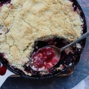 A gluten free plum crumble in a cast iron skillet.