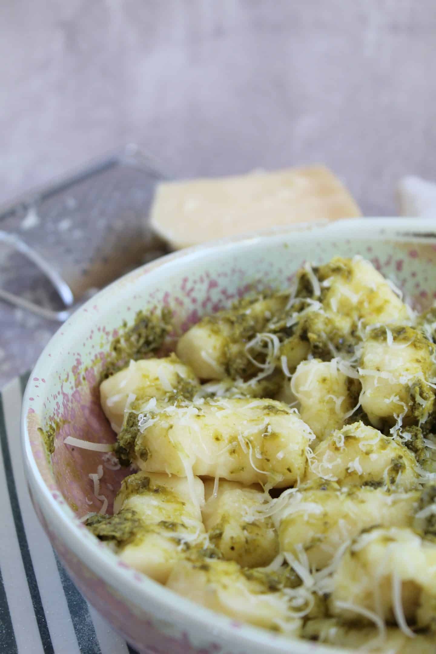 A bowl of gluten free gnocchi with pesto.