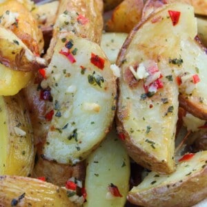 A bowl of gluten free potato wedges with garlic and chilli.