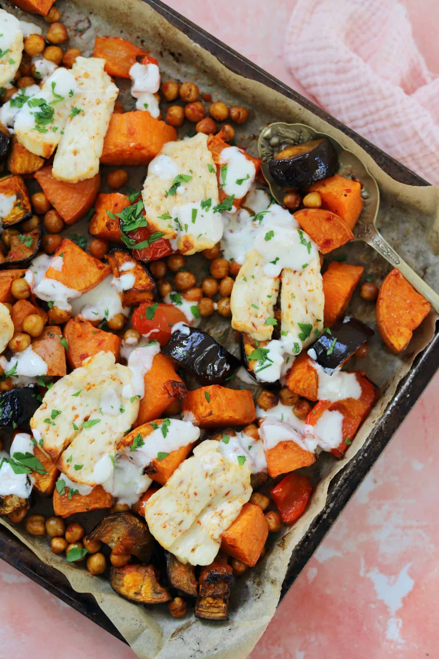 A tray bake with sweet potato, aubergine and halloumi cheese.