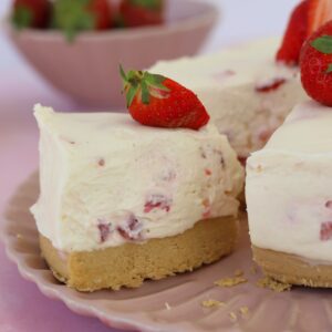A slice of gluten free no bake strawberry cheesecake on a plate.