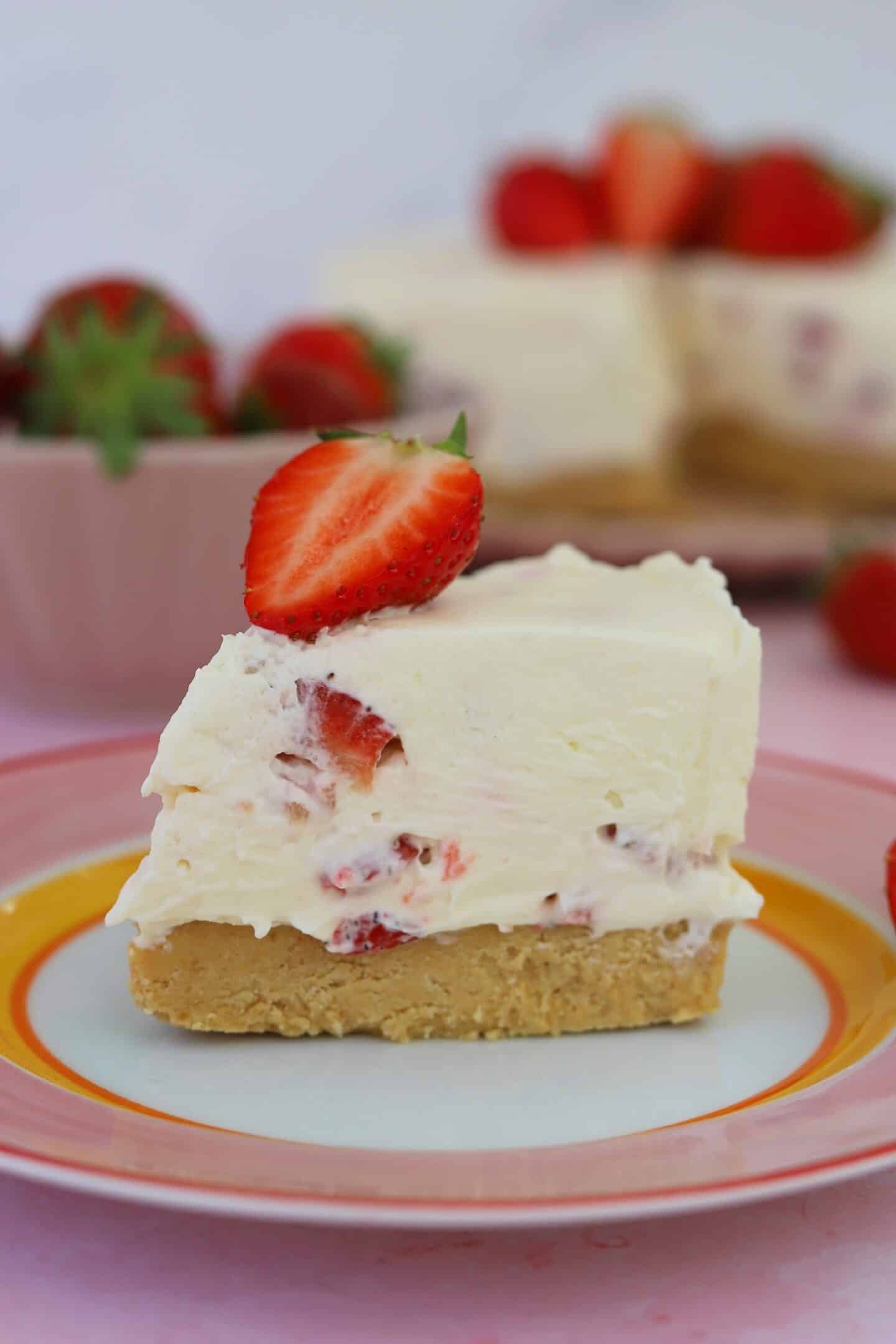 A slice of gluten free no bake strawberry cheesecake on a plate.
