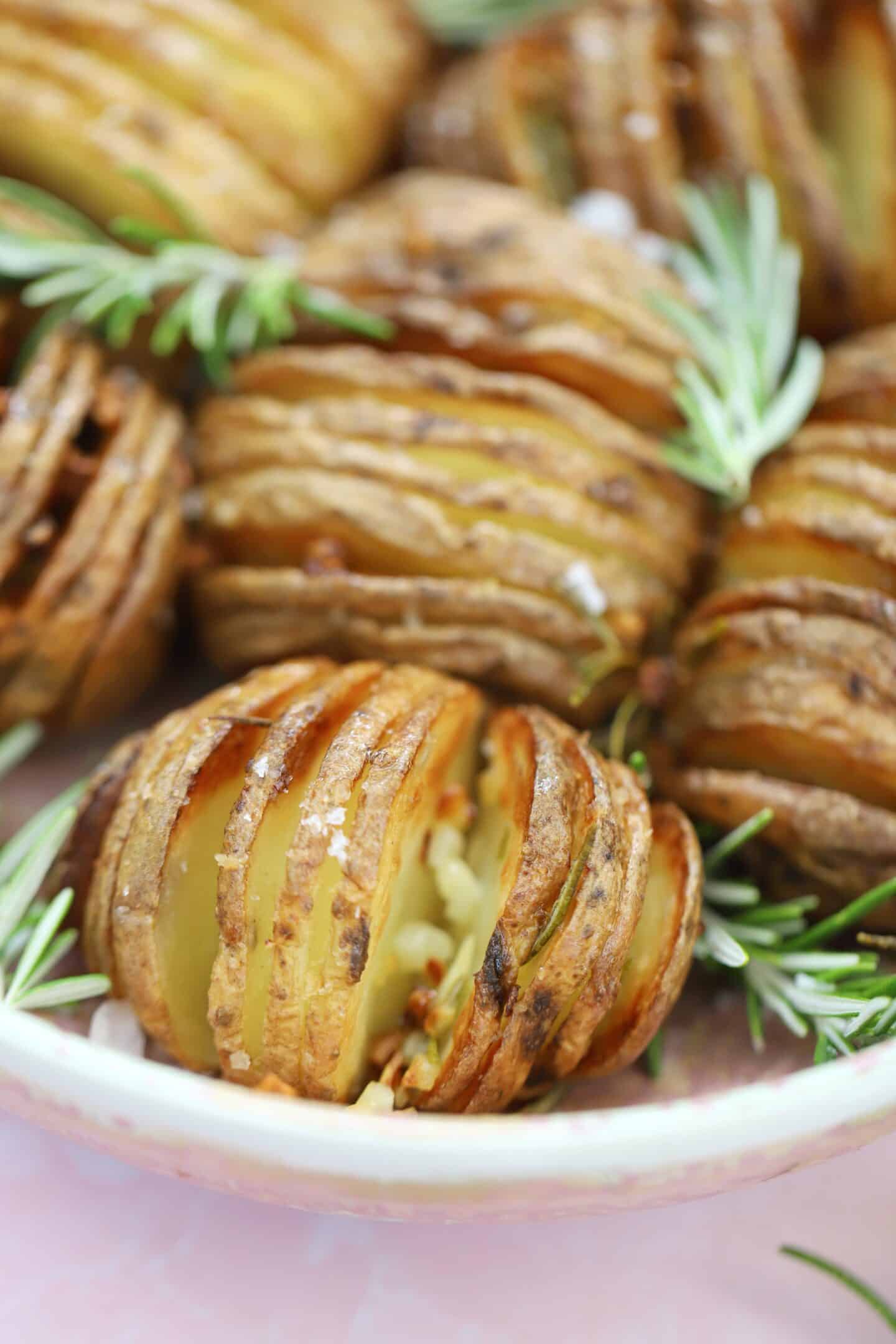 A bowl of air fryer hasselback potatoes.