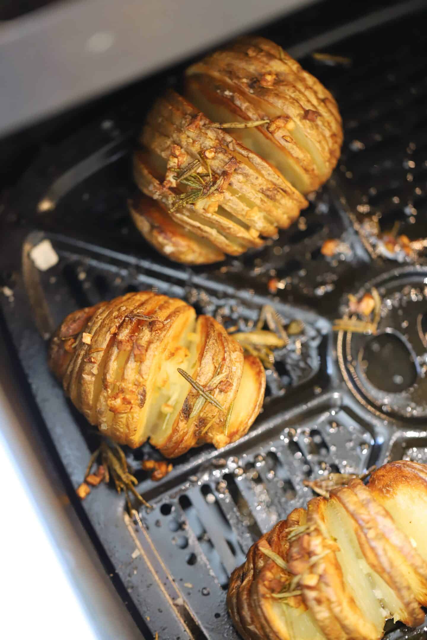 Hasselback potatoes in the air fryer basket.