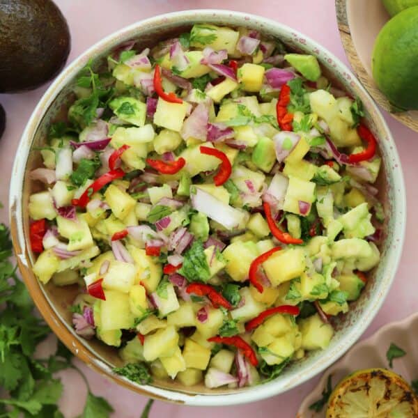 A bowl of avocado pineapple salsa.