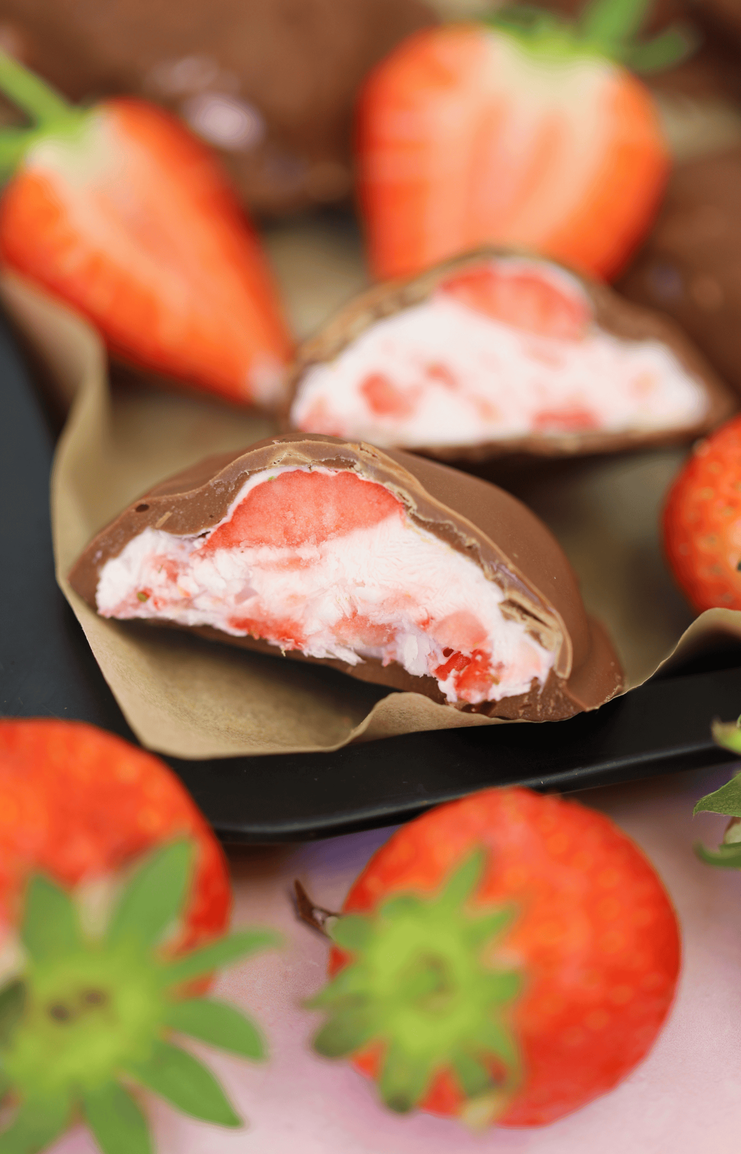 Frozen strawberry yoghurt bites covered in chocolate.