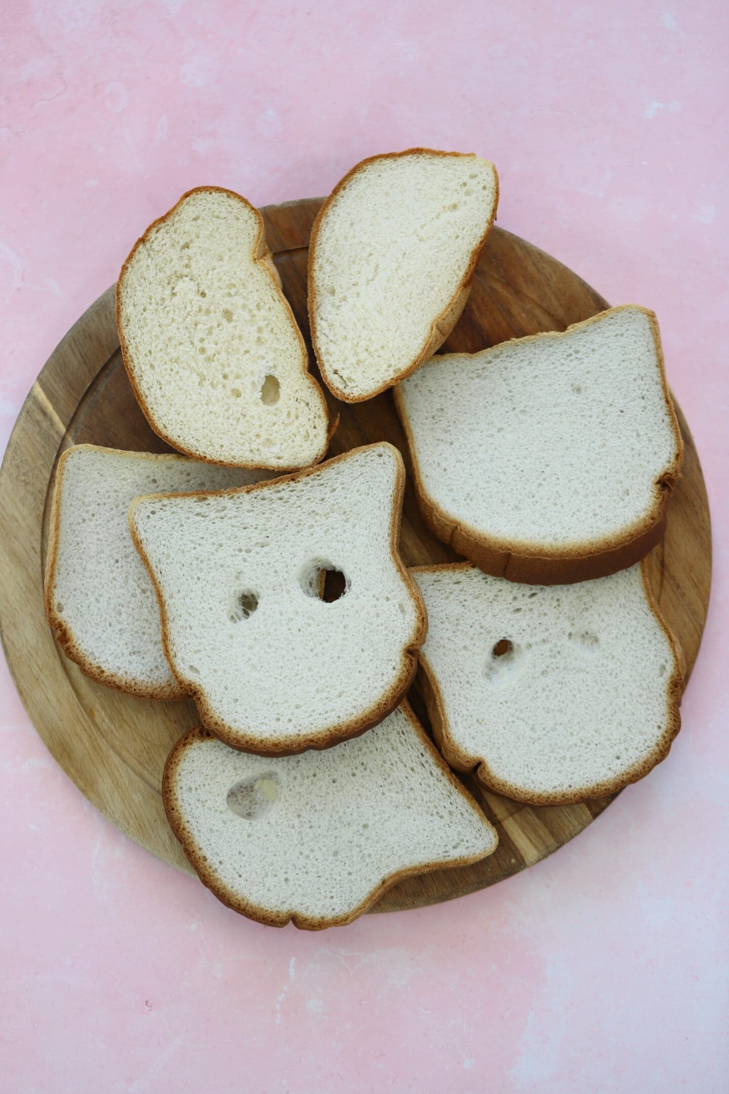 A board of gluten free bread slices with holes.