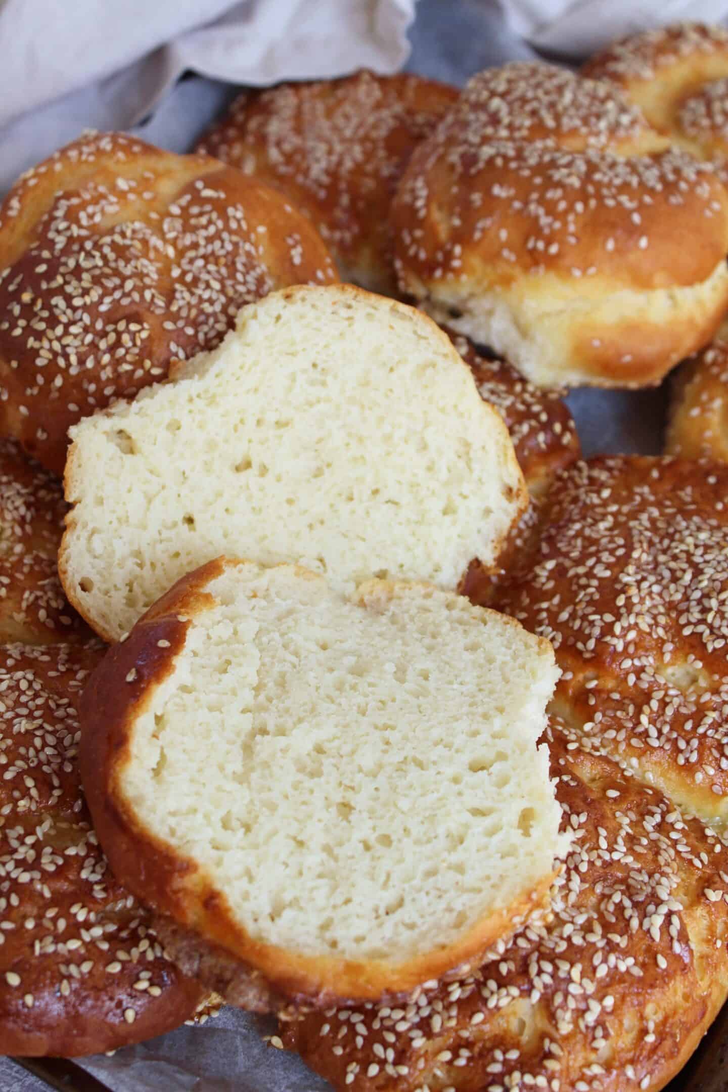 A gluten free brioche bun cut open to show the soft crumb.