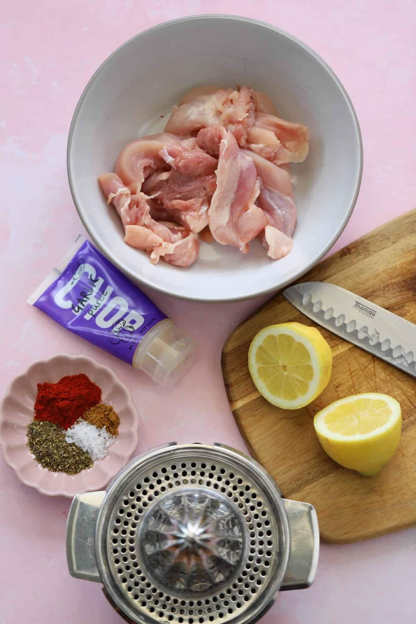 Ingredients the gluten free Greek chicken gyros meat on a pink worktop.