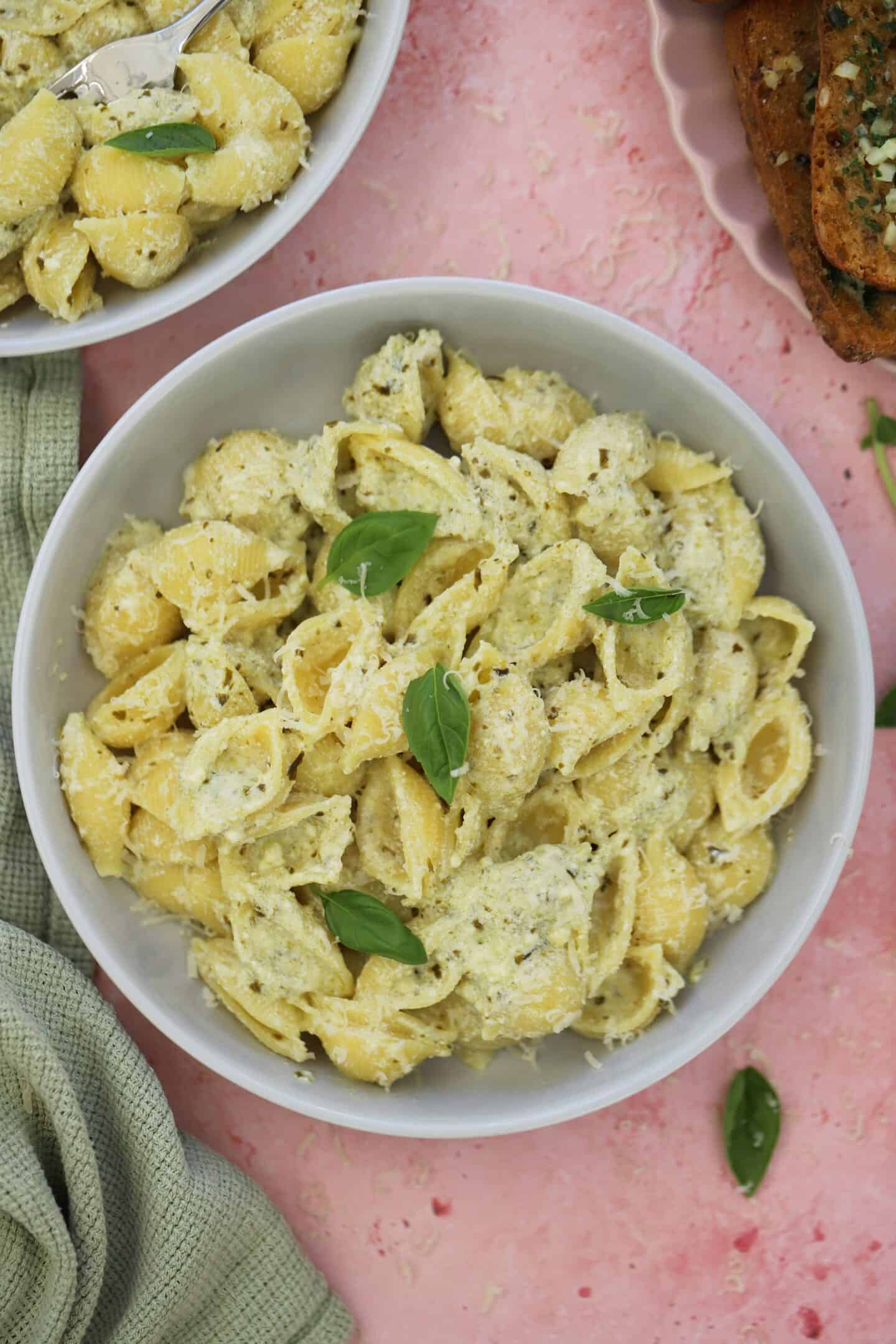 A bowl of gluten free pasta with ricotta pesto sauce.