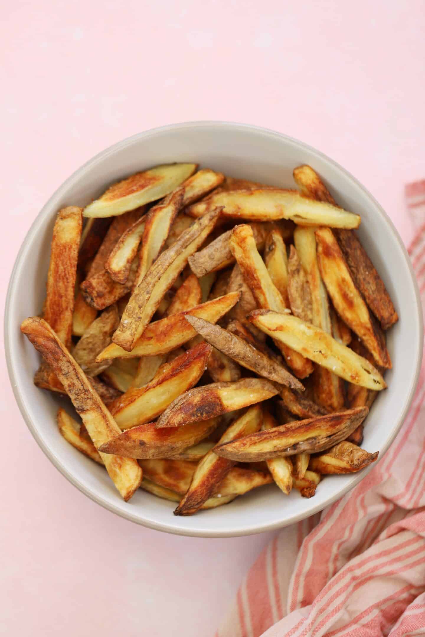 A bowl of skin on fries.