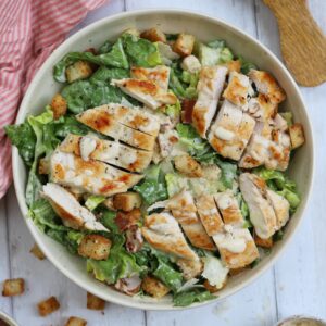 Gluten free chicken caesar salad in a serving bowl.