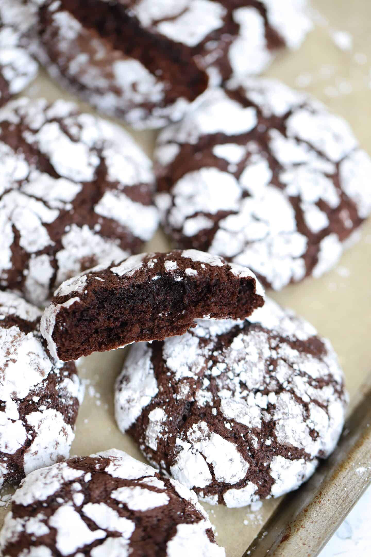 Chocolate fudge crinkle cookies on a baking sheet.