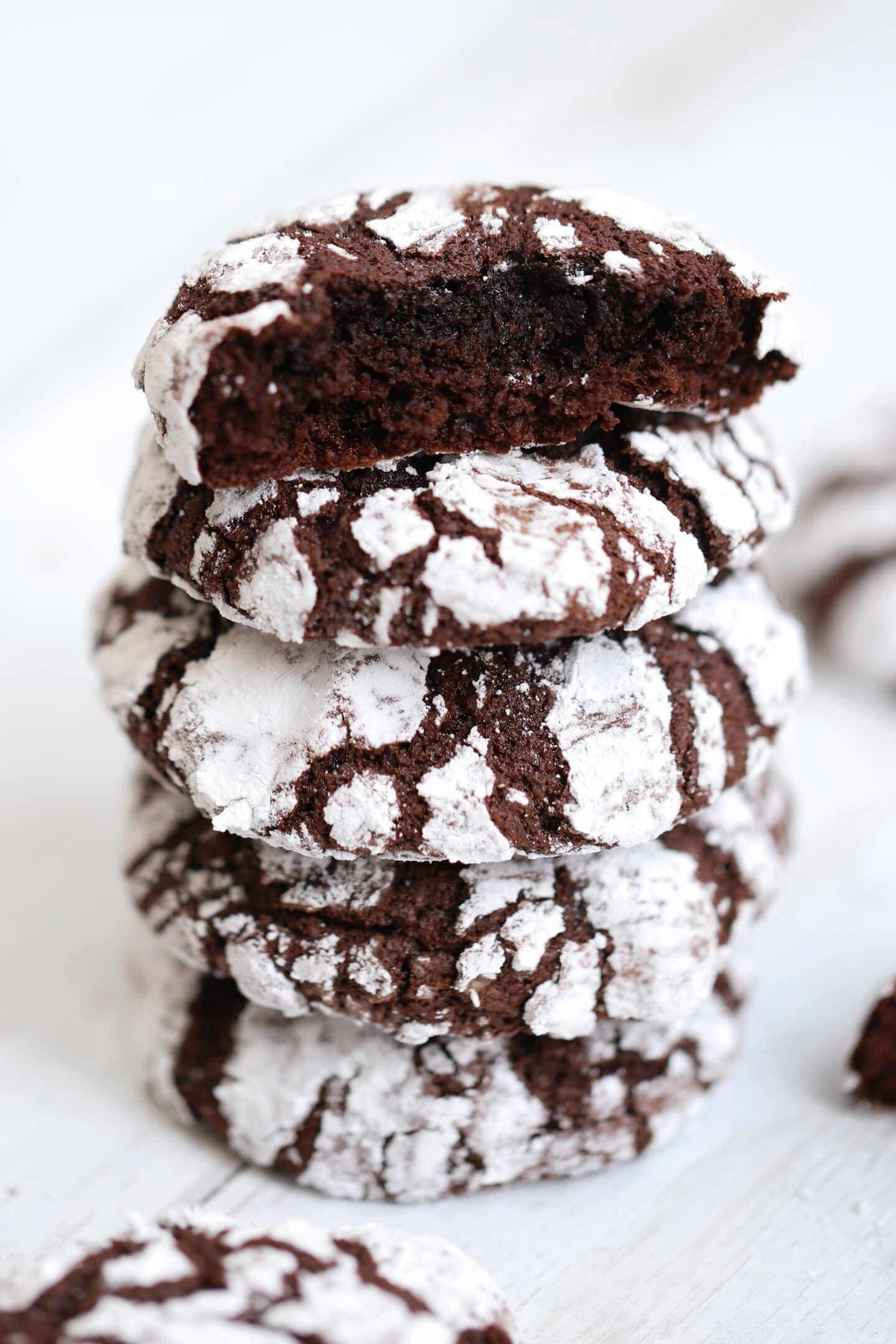 A stack of gluten free chocolate crinkle cookies.