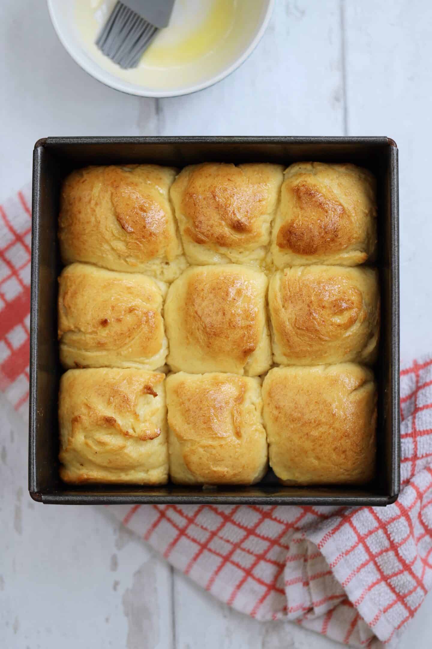 Gluten free Hawaiian rolls in a baking tin.