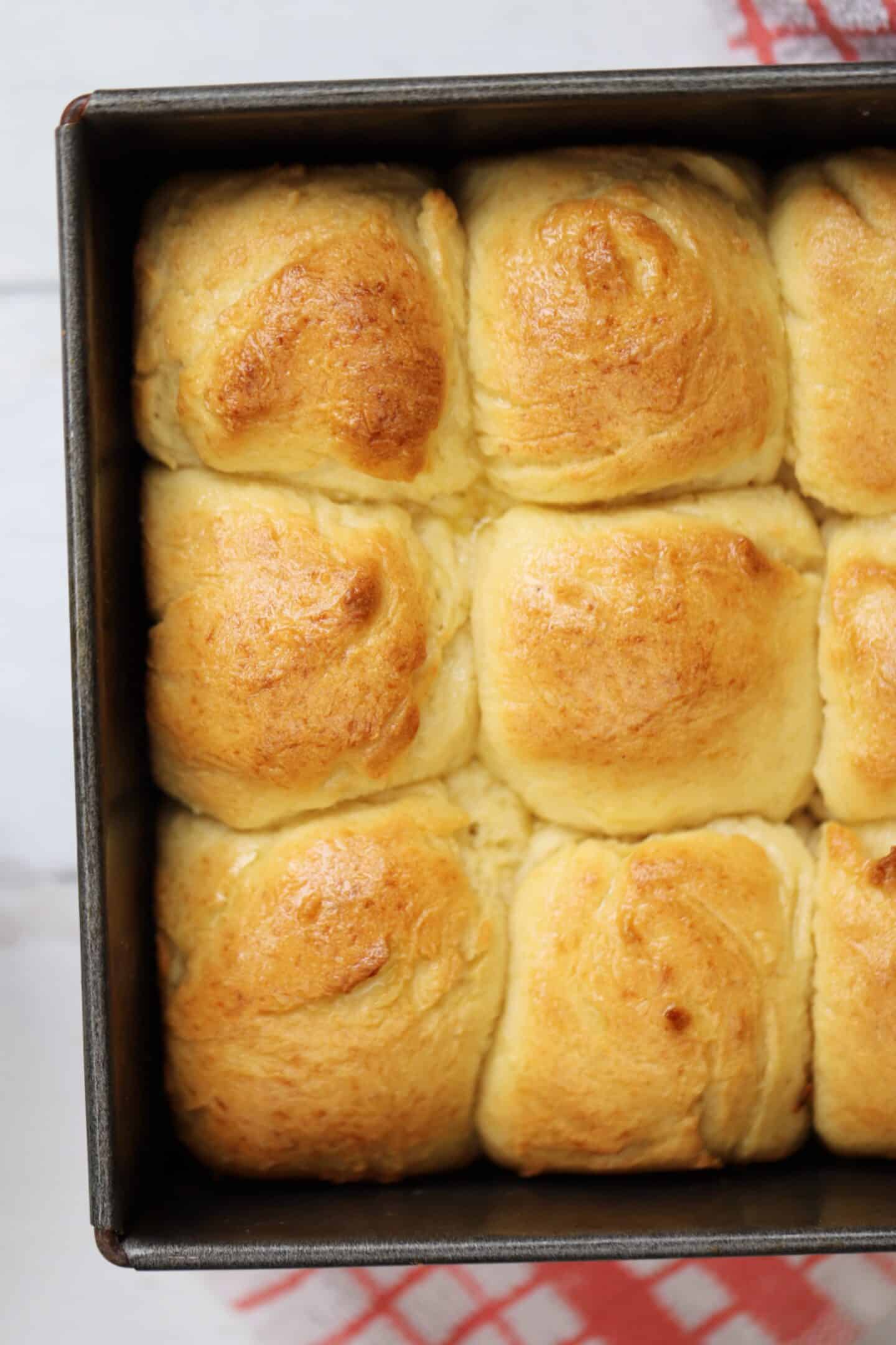 Gluten free Hawaiian rolls in a baking tin.