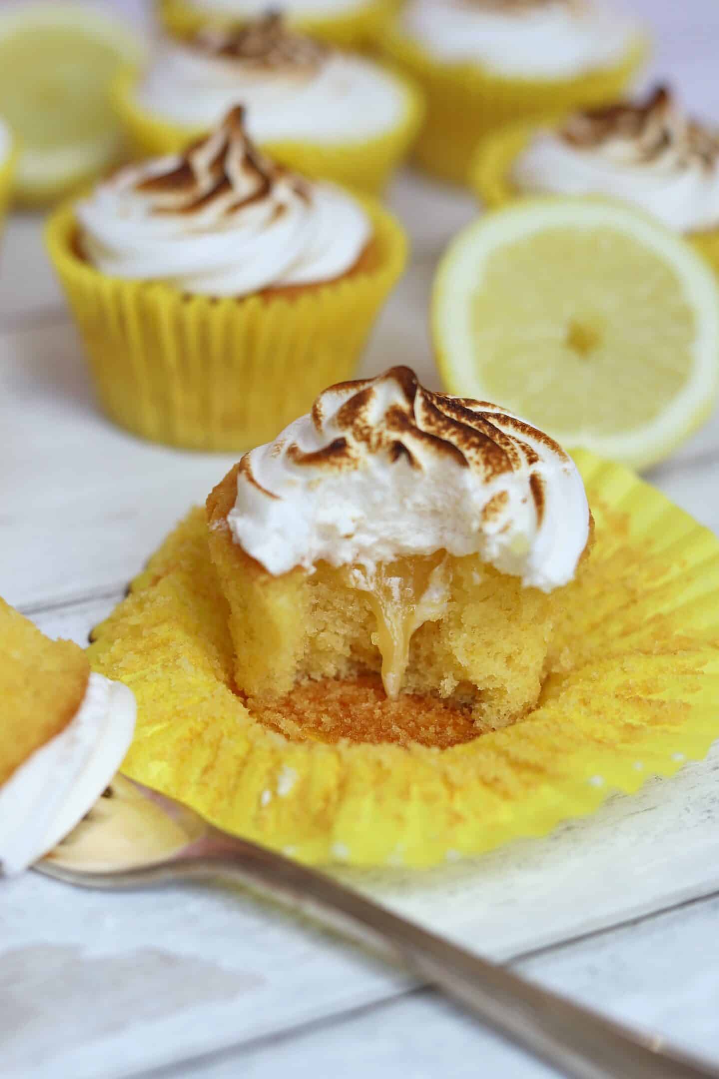 A lemon cupcake with lemon curd centre, with meringue on top.