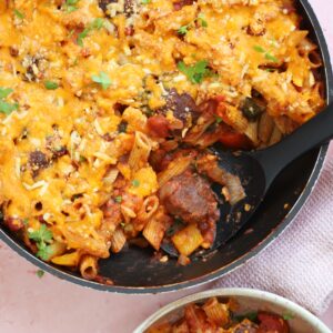 A pan of gluten free meatball pasta bake with a spoonful taken out.