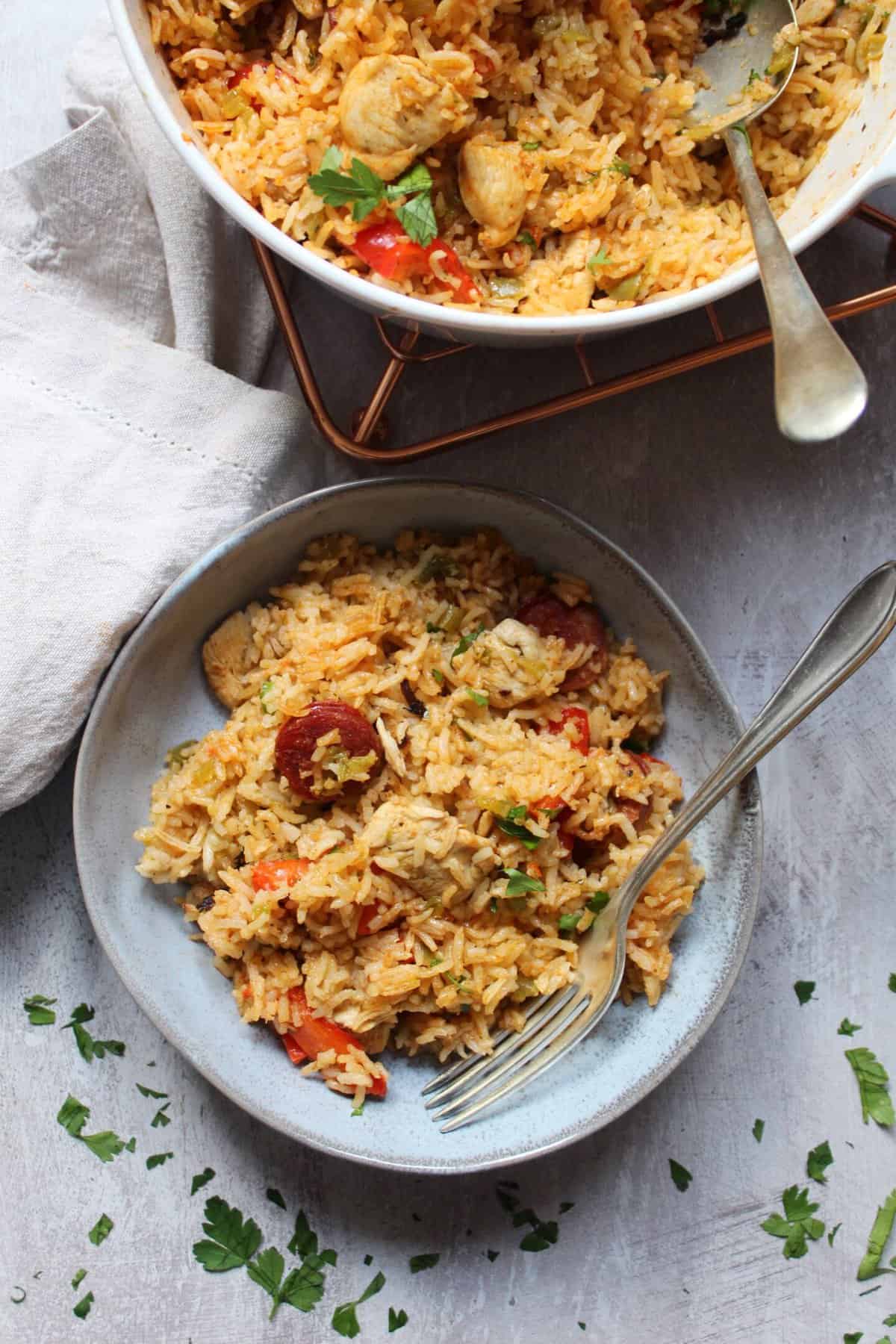 A bowl of jambalaya with chicken, chorizo and red peppers.