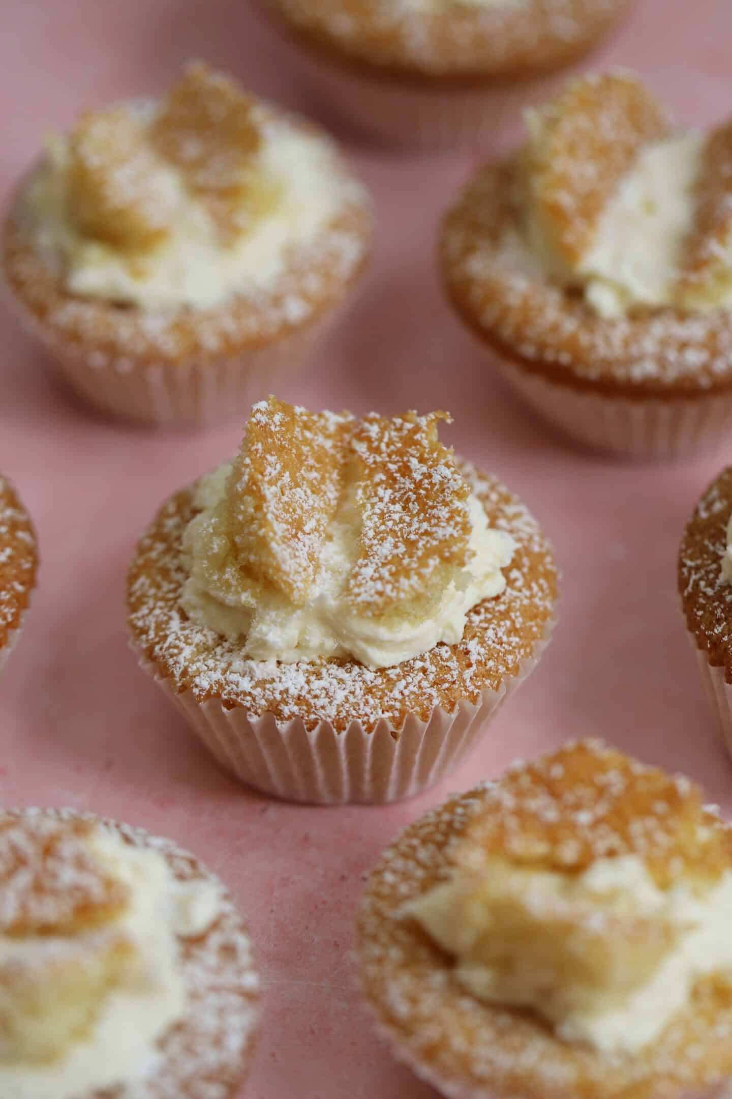 Gluten free butterfly cakes on a pink backdrop.