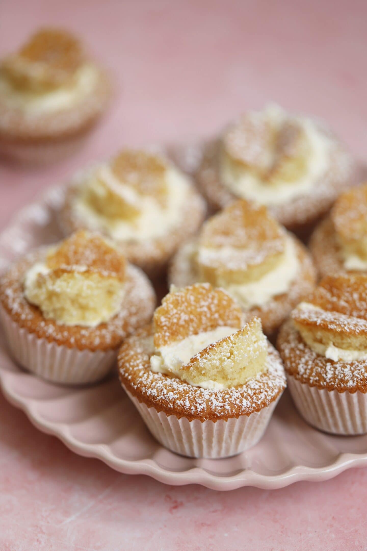 A pink plate with gluten free butterfly cakes on.