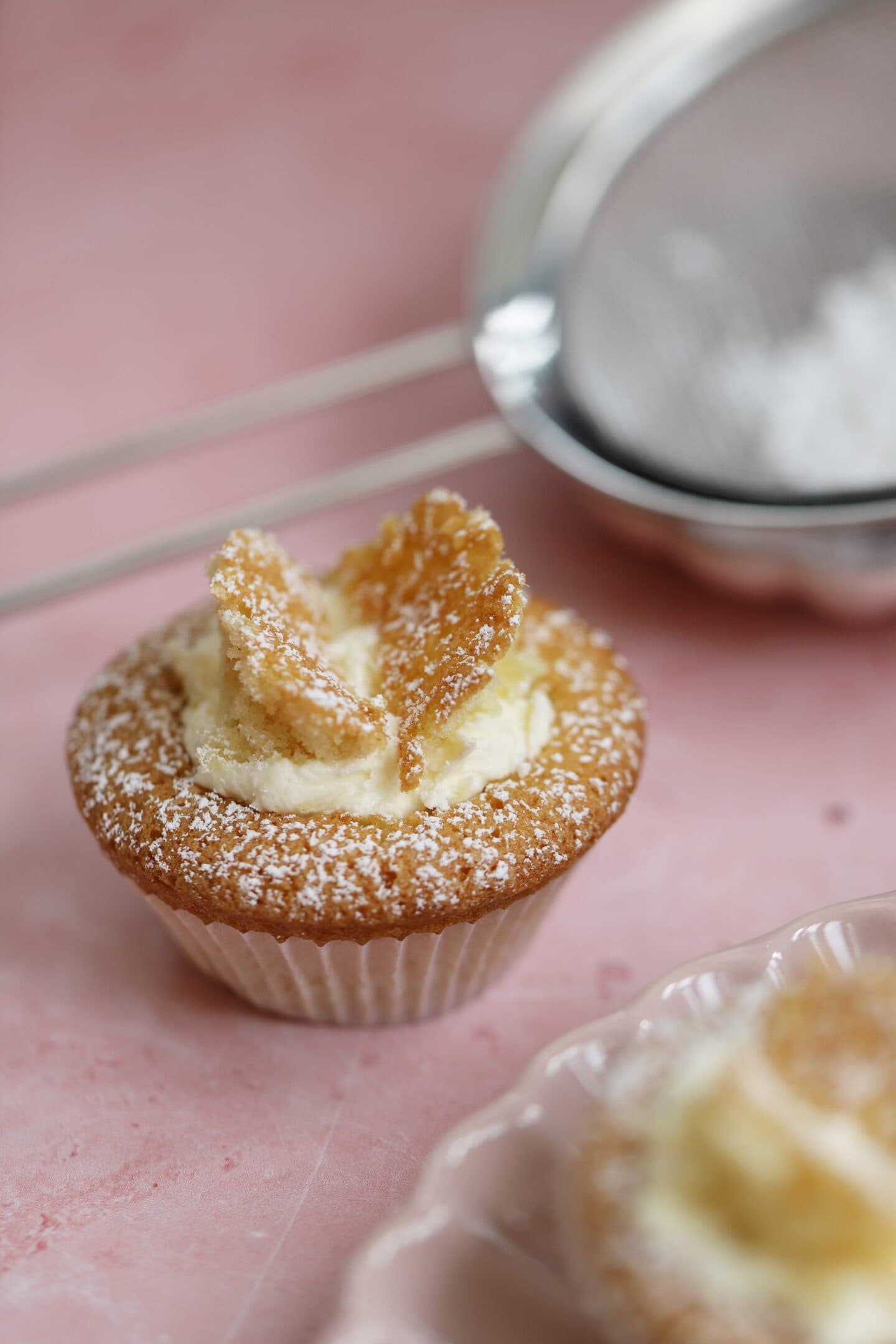 A gluten free butterfly cake on a pink backdrop.