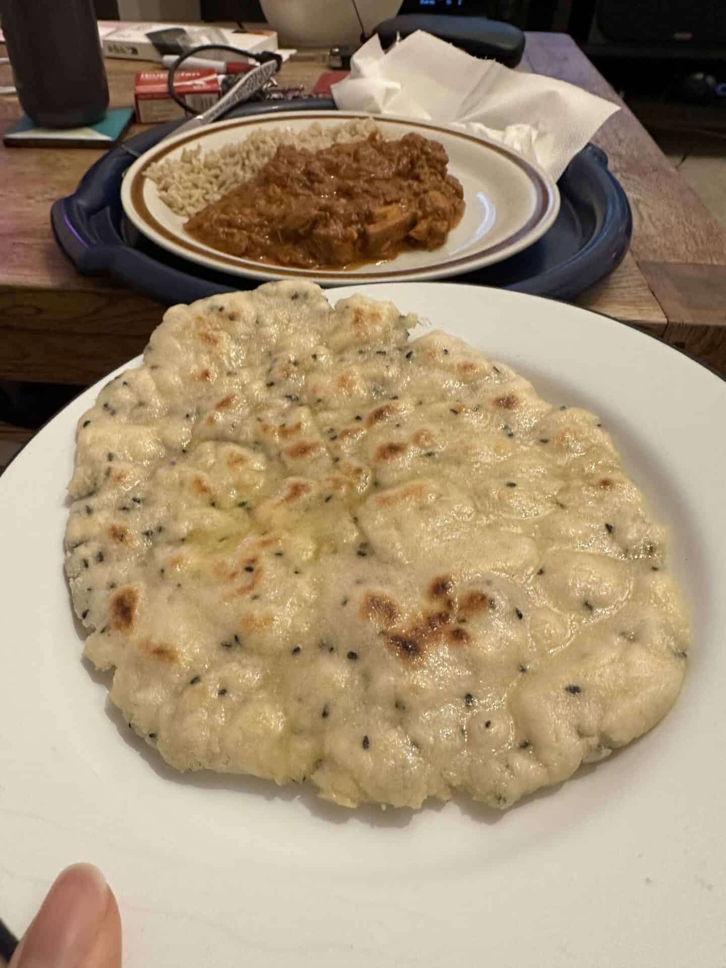 Gluten free naan bread with a curry.