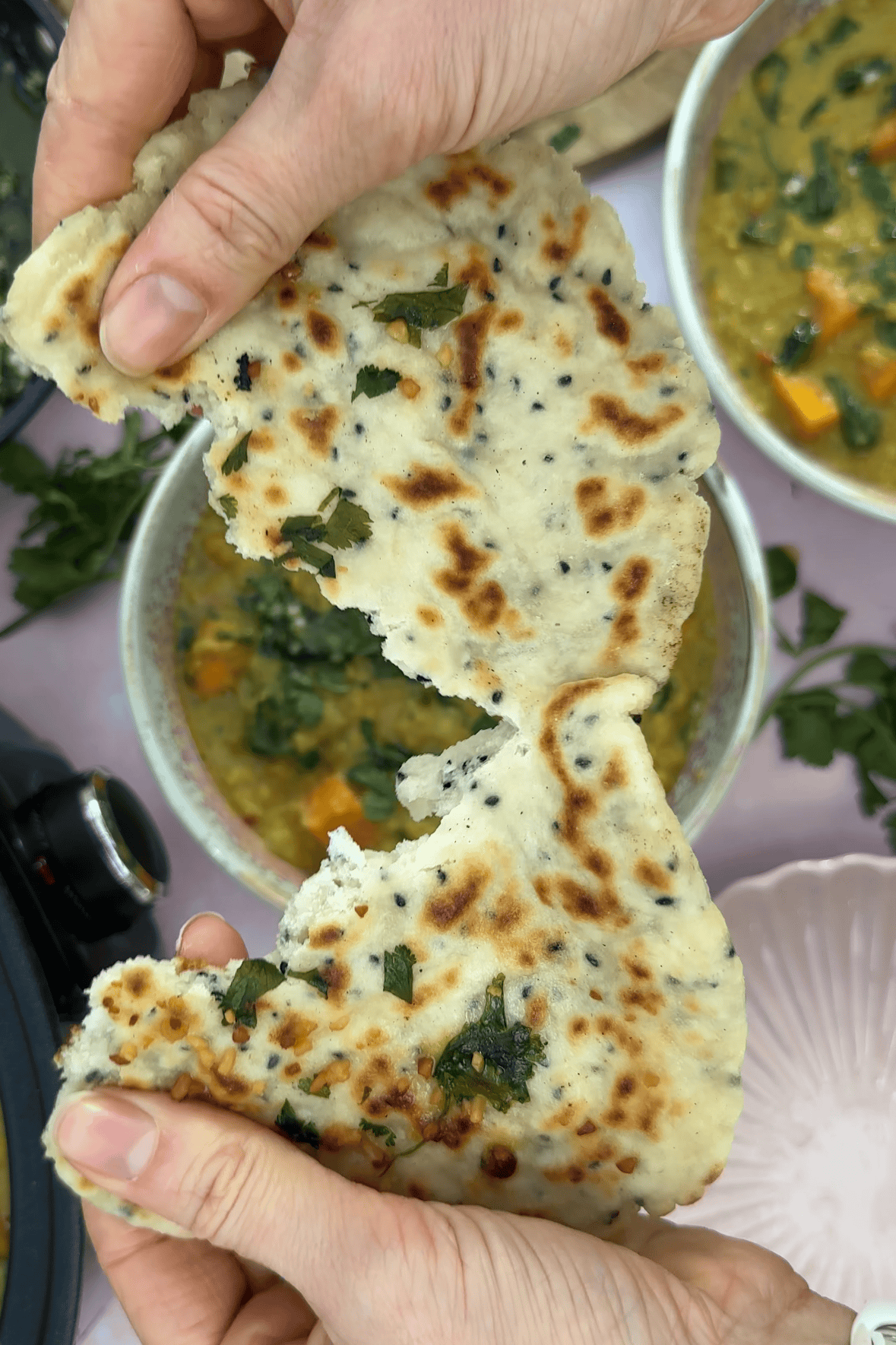 Tearing a gluten free naan bread.