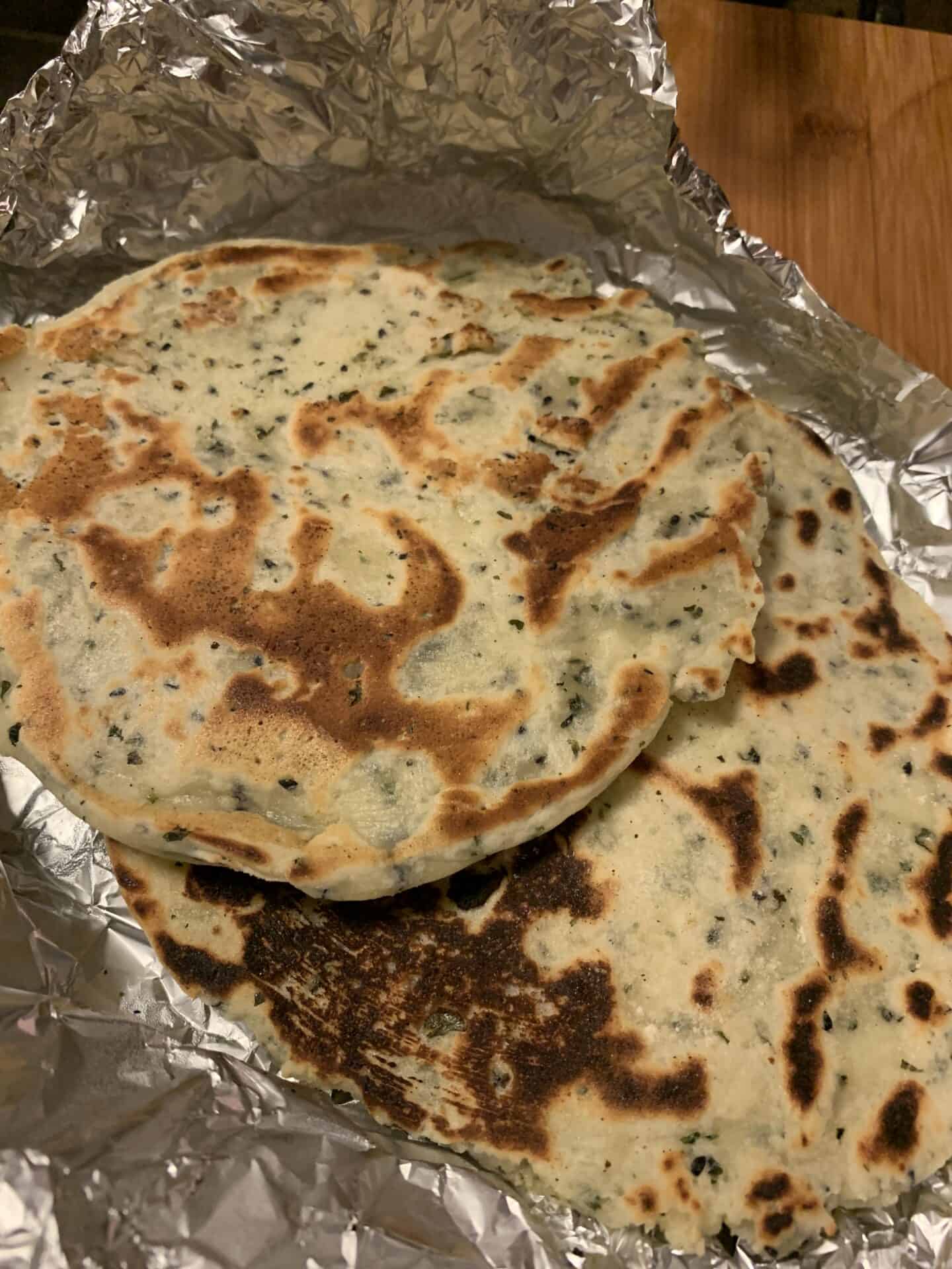 A pile of gluten free naan breads.