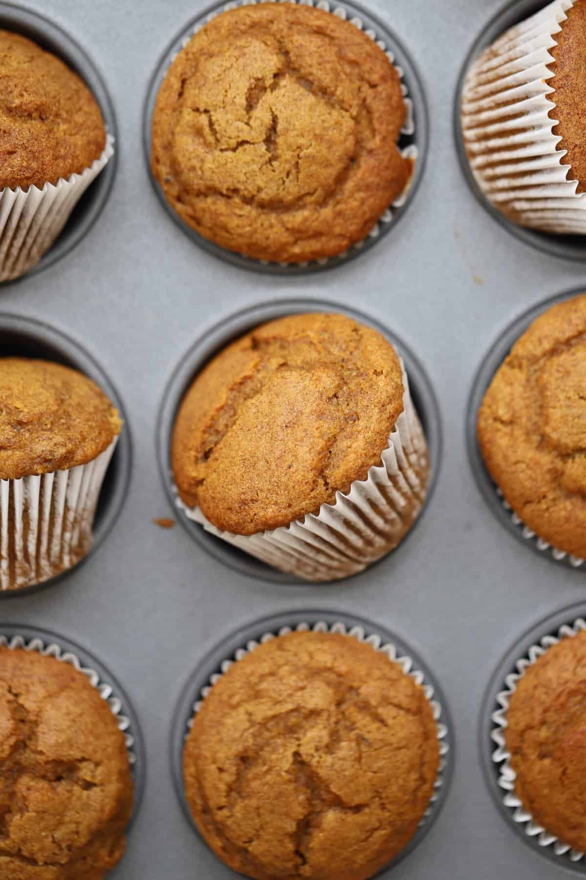 Pumpkin banana muffins in a baking tin.