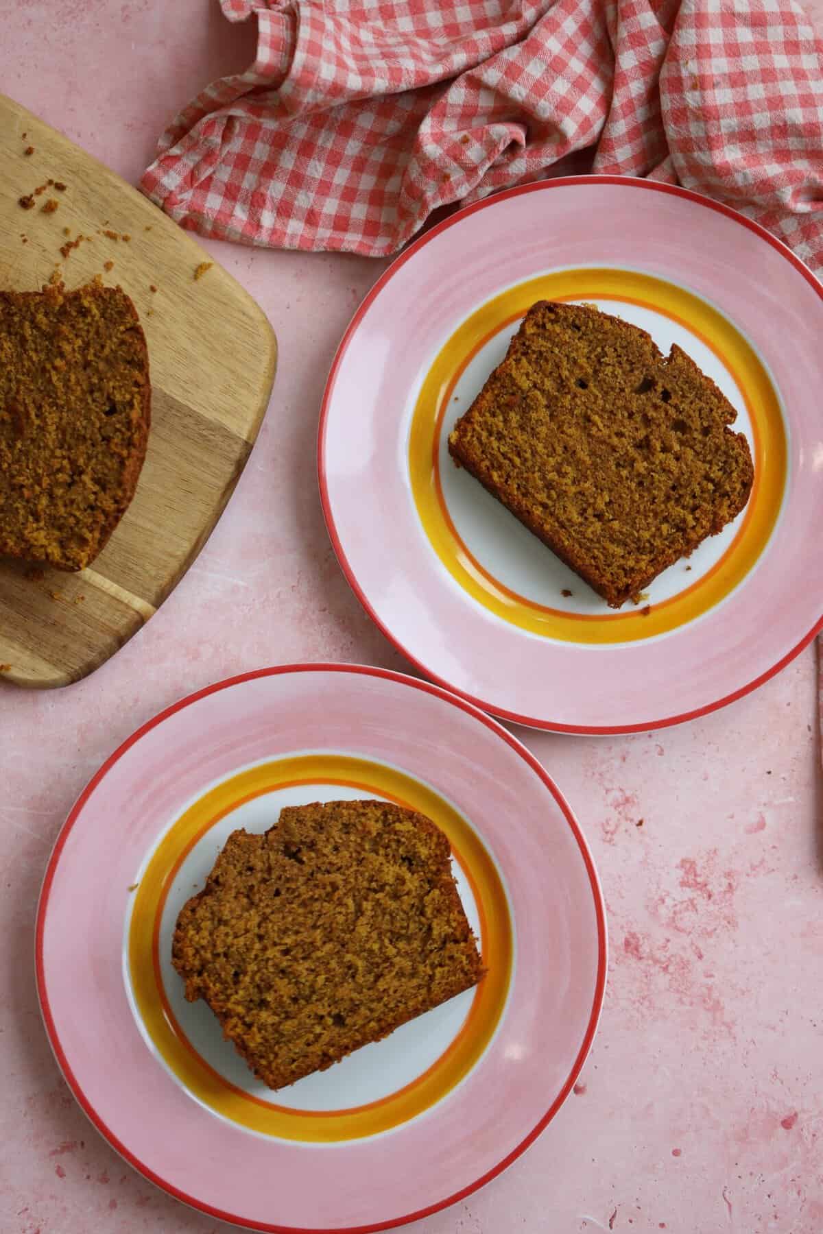 Slices of gluten free pumpkin bread on pink plates.