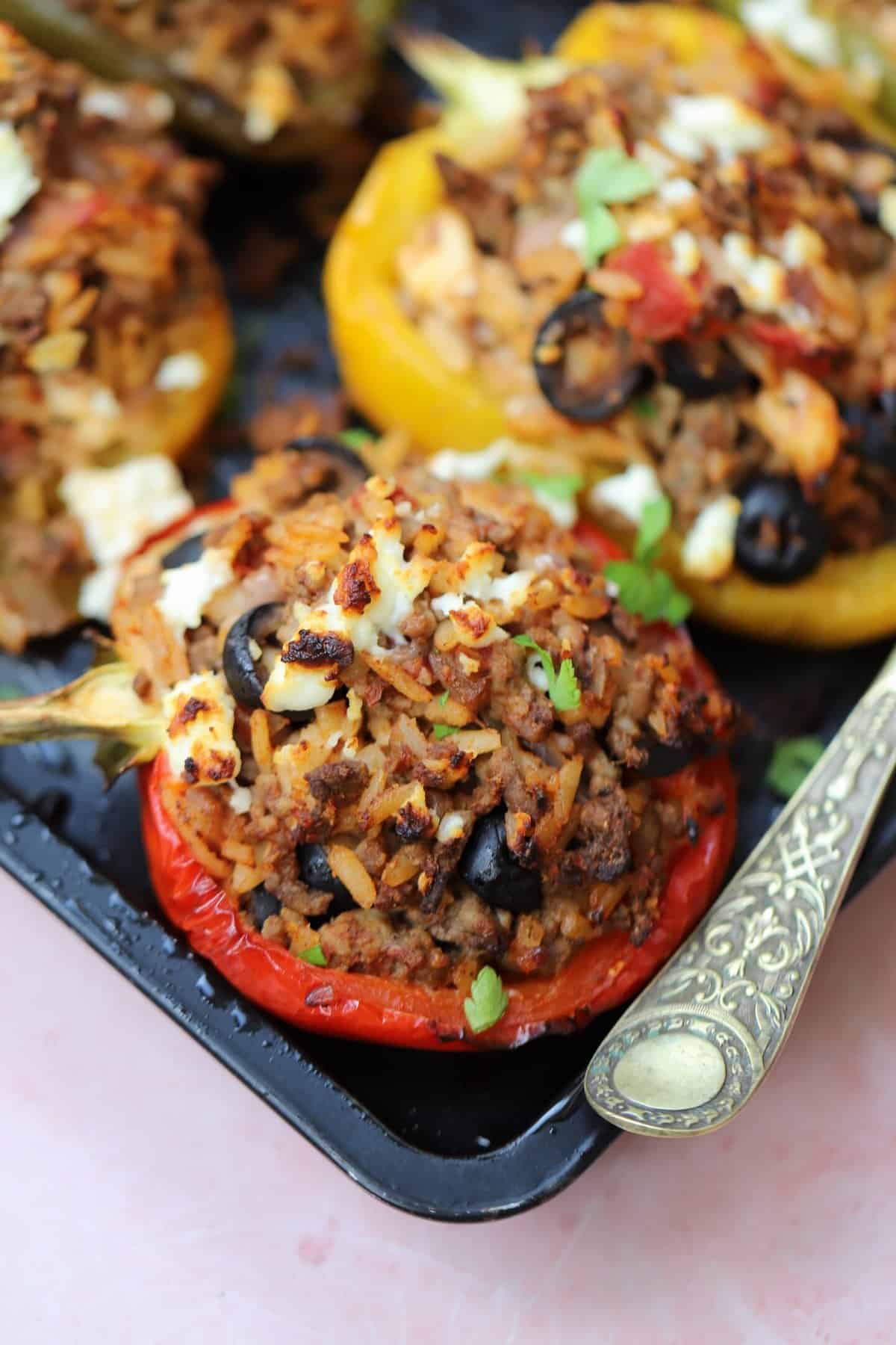 A stuffed gluten free bell pepper on a tray.