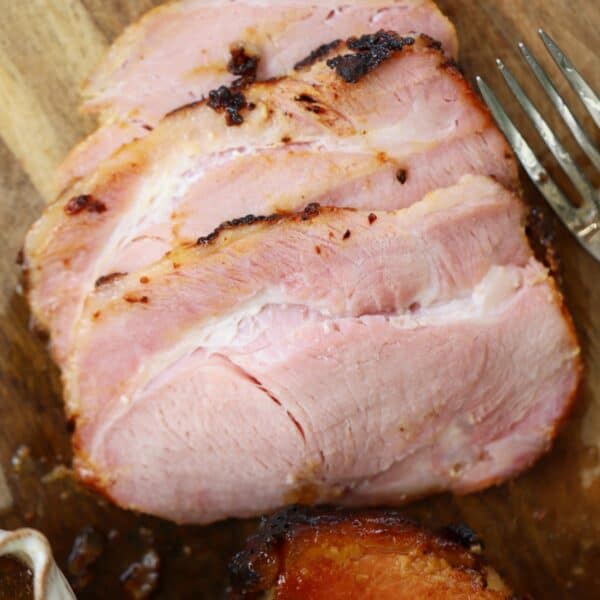 Slices of air fryer gammon on a chopping board.