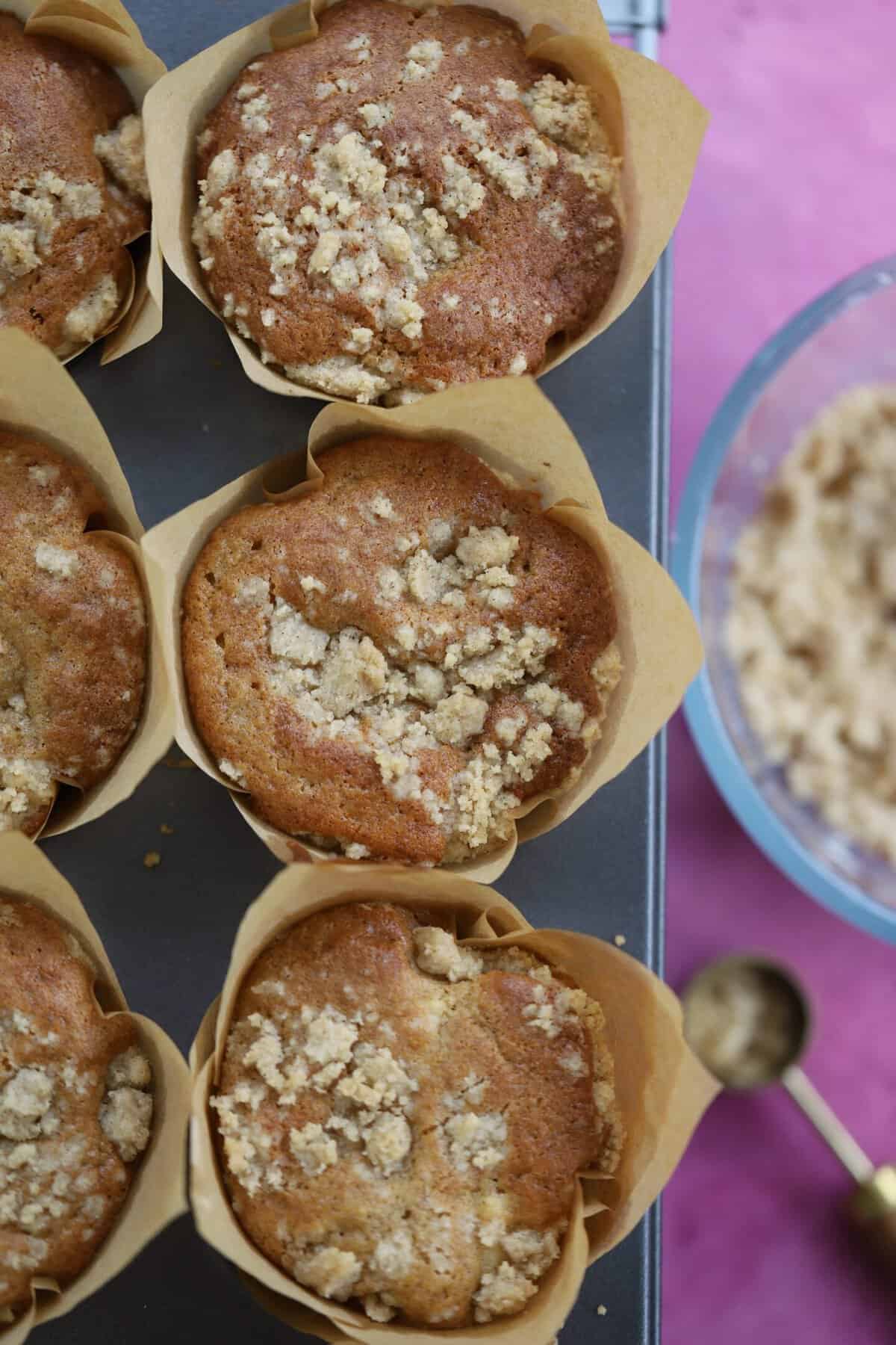 Overhead shot of apple muffins in a baking tin.