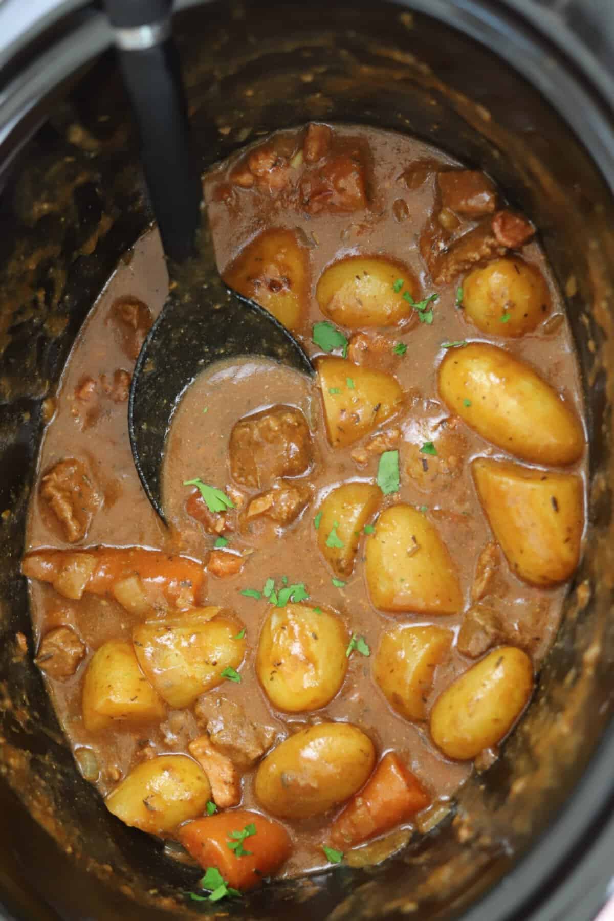 A slow cooker filled with beef and ale stew.