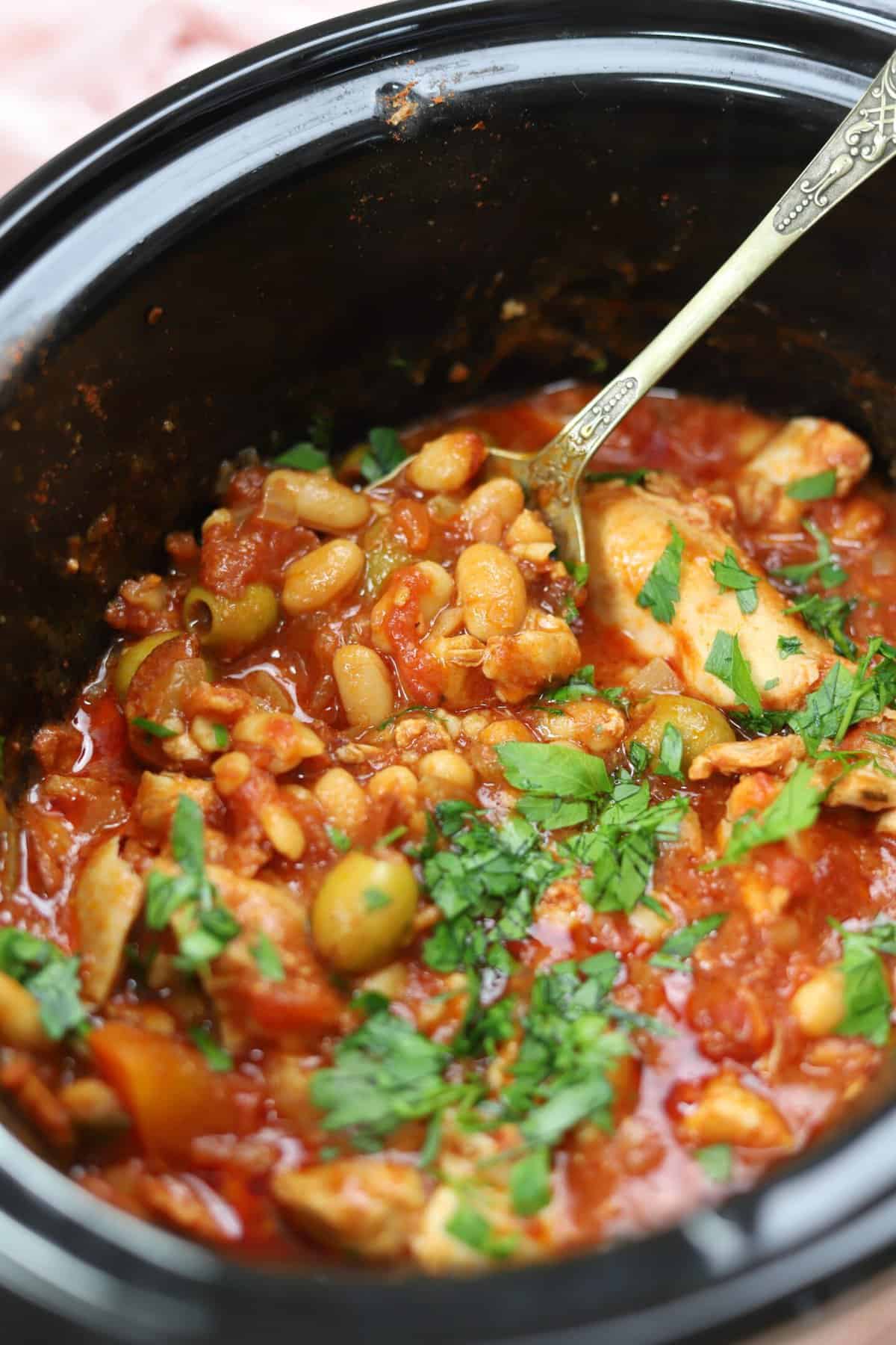 A crock pot full of Spanish chicken stew.