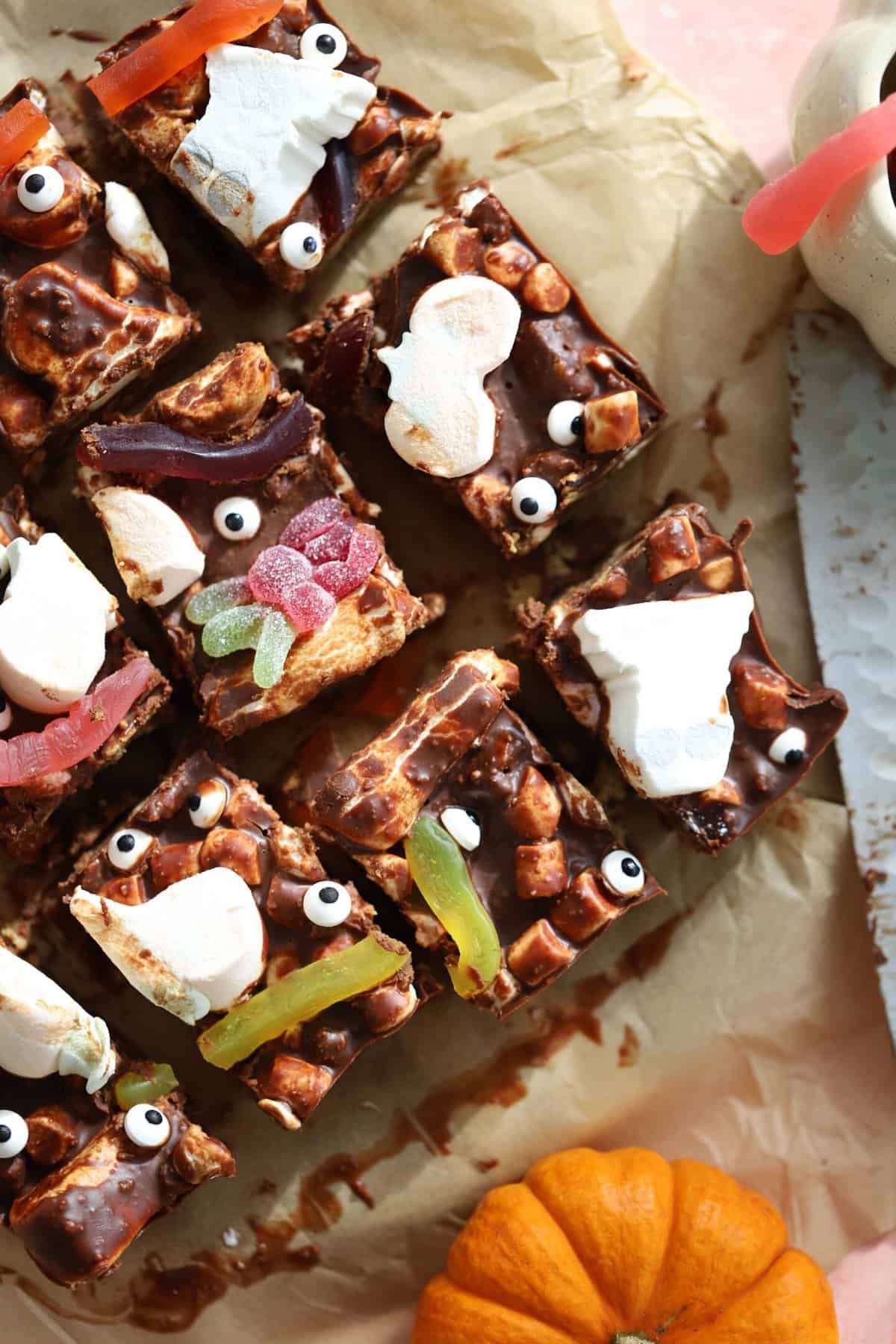 Overhead shot of Halloween rocky road squares on baking paper.