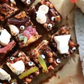 Overhead shot of Halloween rocky road squares on baking paper.