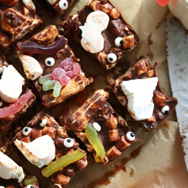 Overhead shot of Halloween rocky road squares on baking paper.