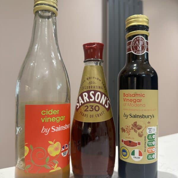 Three bottles of different vinegars.