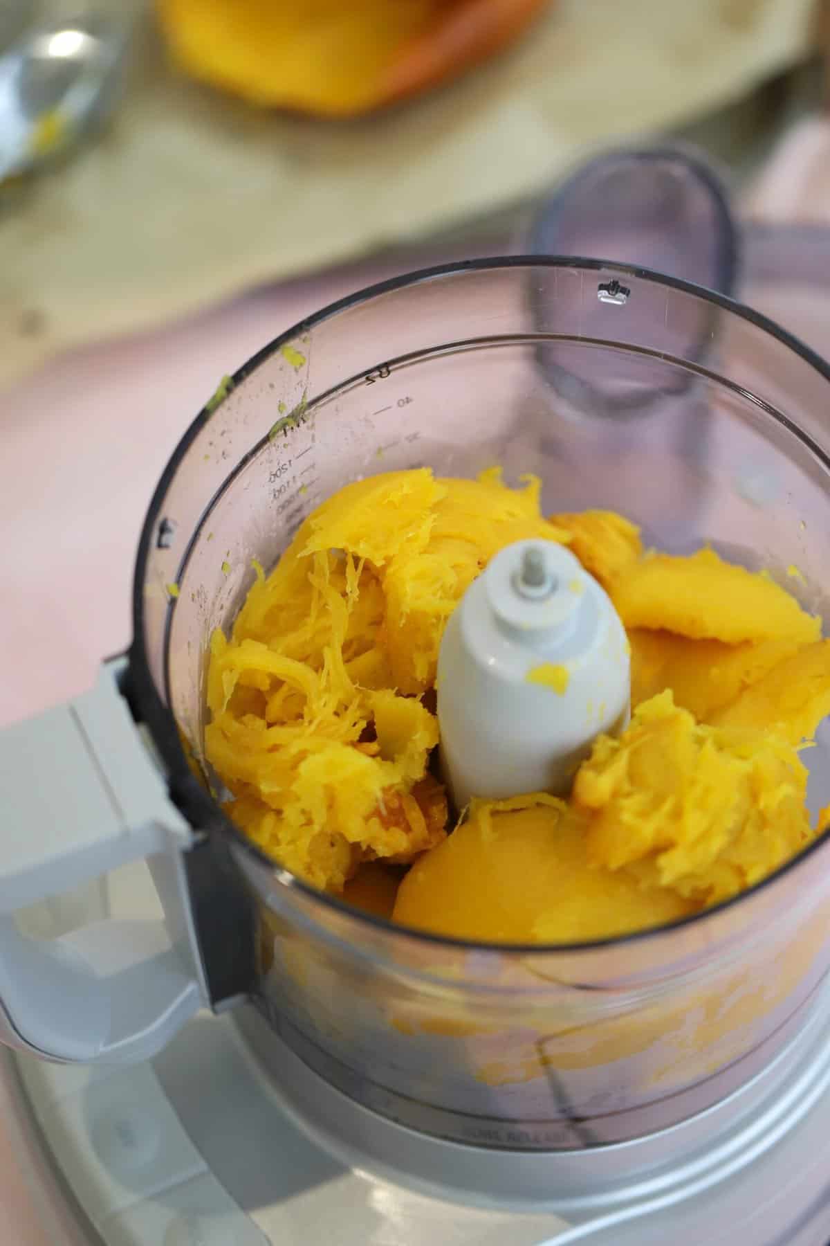 The pumpkin flesh in a food processor ready to be pureed.